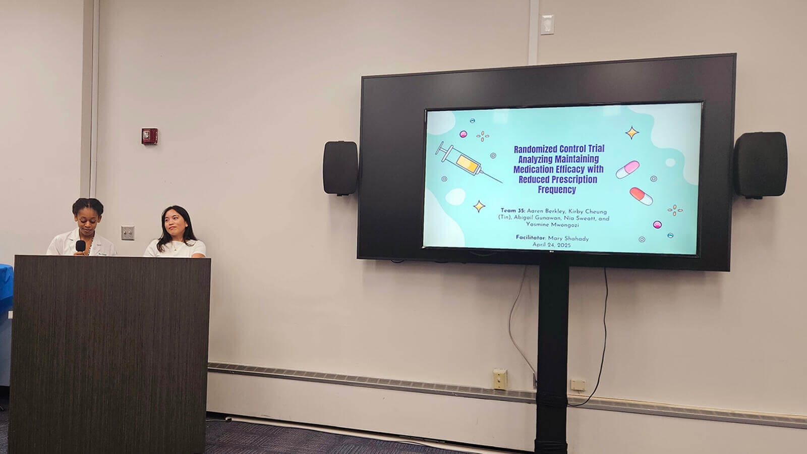 Two people presenting on Medication efficacy