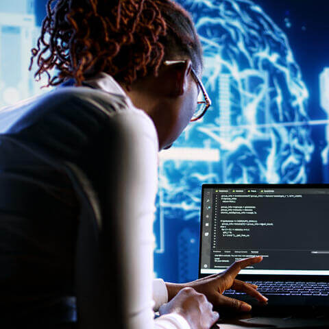student coding on computer