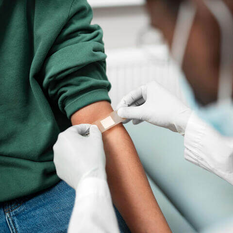 A doctor applying a band-aid